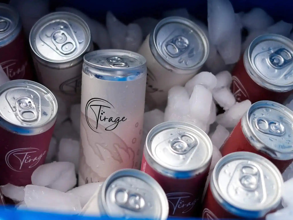 Cans of 'Tirage' and other brands in a cooler with ice